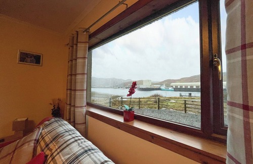 Badcall Cabaña | The location overlooking the sea loch and harbour with fishing boats coming and going is amazing.