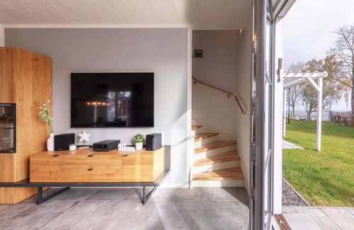 Fuhlendorf Casa | 5-star vacation home Ostseetraum on the water with fireplace, terrace and Bodden view
