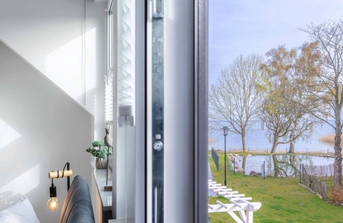 Fuhlendorf Casa | 5-star vacation home Ostseetraum on the water with fireplace, terrace and Bodden view