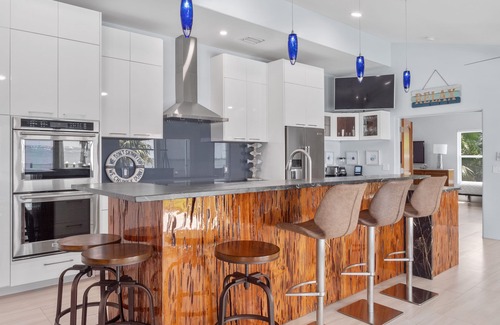 Fort Pierce Casa | 5BR/4.5B Beach House- heated pool, deep water dock, walk to beach!