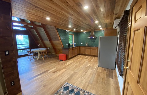 Allegan Casa | A-frame cabin nestled in forest, stunning lake view, perfect serenity.