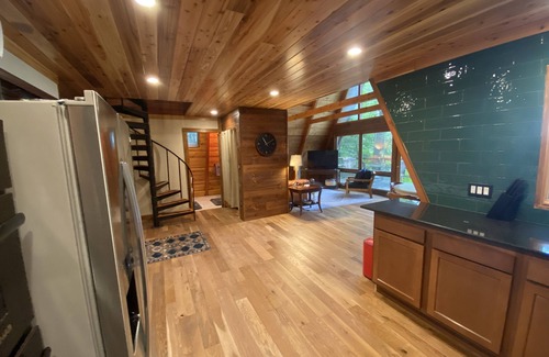 Allegan Casa | A-frame cabin nestled in forest, stunning lake view, perfect serenity.
