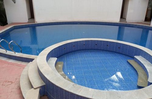 Bengaluru Casa | Amazistay offers Luxury room with private bathroom, balcony & 55 inch TV & shared Jacuzzi paid access, Book Lover, near Ramaiah College Hospital