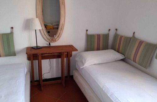 Capo Ferro Casa | Apartamento con vistas al mar a 30 metros de la playa de Cala del Faro