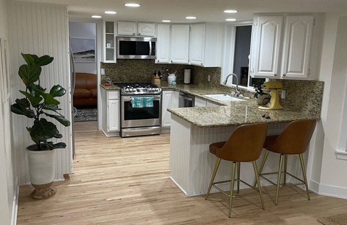 River Bottoms Casa | Beachy Home in Provo. Large deck with builtin hot tub, Fire pit, Palapa