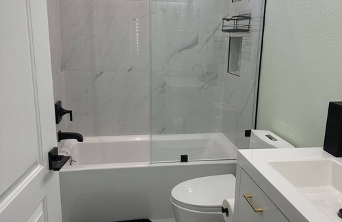 San Fernando Casa | Bedroom and bathroom in a quiet townhouse.