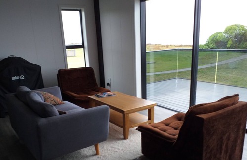 Waiotahi Casa | Big Black Beachfront Bach in family friendly community.