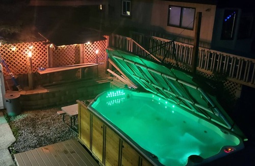 Alto Casa | Campau Lake 1st level · Lake level hot tub spa, TIki bar, lakefront