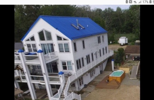 Alto Casa | Campau Lake 1st level · Lake level hot tub spa, TIki bar, lakefront