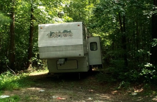 Wake Forest Casa | Camper off home in wooded property small creek.