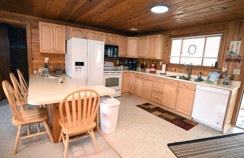 Prudenville Cabaña | Centrally located, four season retreat w/firepit and lakeview.