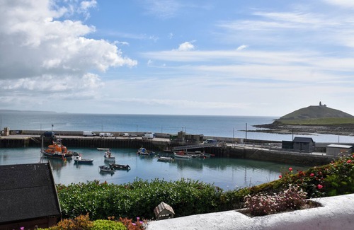 Garryvoe Cabaña | Charming Coast guard cottage overlooking Ballycotton harbour. Garden and yard.