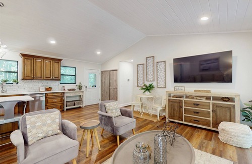 Sylva Casa | Riverfront getaway with a deck, yard, private hot tub, fireplace, and grill