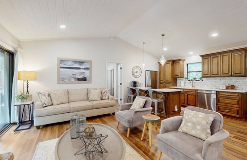 Sylva Casa | Riverfront getaway with a deck, yard, private hot tub, fireplace, and grill
