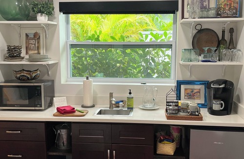 Parrot Cove Cabaña | Chill on the patio overlooking the pool & lush gardens & grill your dinner!