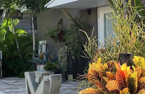 Parrot Cove Cabaña | Chill on the patio overlooking the pool & lush gardens & grill your dinner!