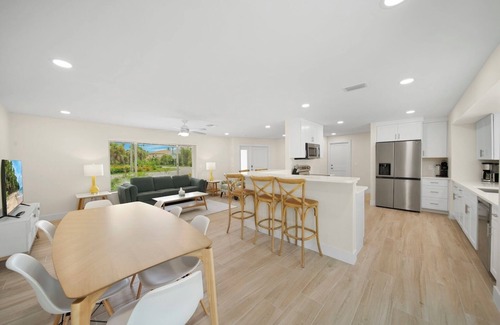 Shell Harbor Casa | Coastal Charm: Stunning Ground Level Pool Home on Canal with EastEnd Location