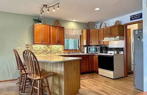 Elmira Cabaña | Cozy beachfront cottage in the woods with walkout basement and wrap-around porch