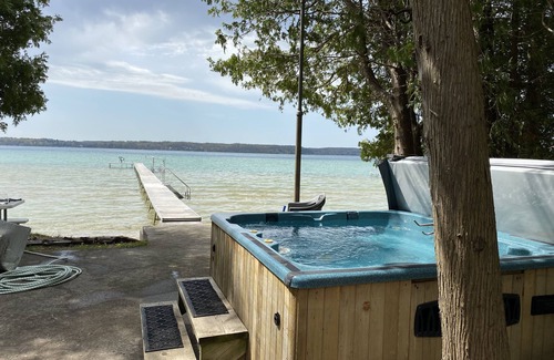 Lake Township Casa | Crystal Lake Waterfront Cottage with Private Dock, Yard, & Hot Tub