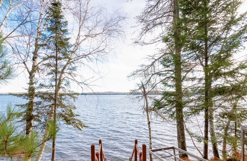 Presque Isle Cabina | Dog-friendly lakefront cabin with on-site swimming, fishing, & rec room