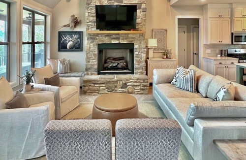 Rogers Casa | Elegant lakefront home with a fireplace, screened patio & lovely views