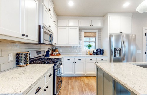 Rogers Casa | Elegant lakefront home with a fireplace, screened patio & lovely views