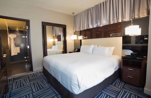 Downtown Dallas Hotel | Elegant Suite with King Bed, Lounge Area, and Designer Details