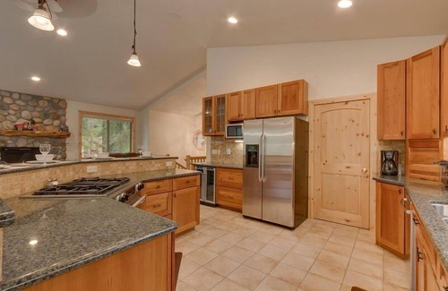 Tahoe Island Casa | Enjoy the tree-lined yard, spacious deck, and hot tub!