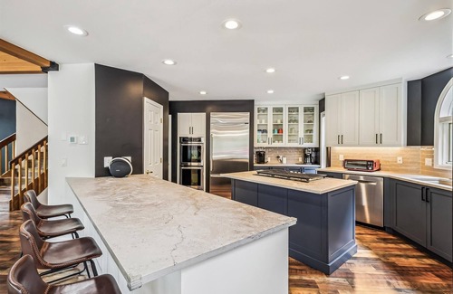 Dunkin Hill Casa | Experience luxury at Stormbunker Paradise, a spacious 4-bedroom house with stunning wooded views.