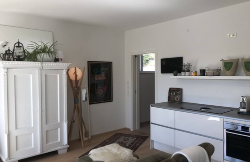 Riedenburg Apartamento | Apartamento con terraza de madera y ducha a ras de suelo para dos personas.