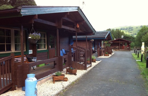Ynysddu Cabina | Finish Holiday Lodges, ubicado en la ladera boscosa, con vistas a la montaña y al arroyo
