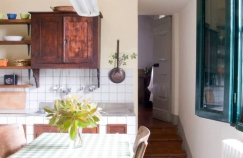 Bacchereto Casa | Flower house, surrounded by greenery, overlooking a large garden.