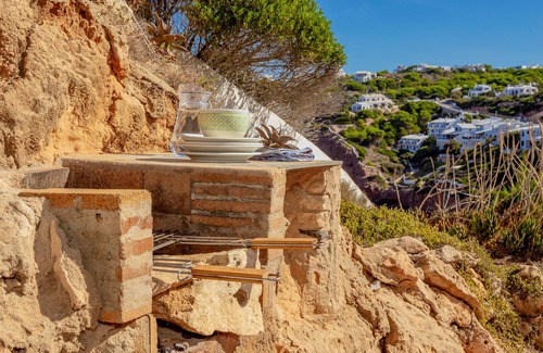 Ciutadella de Menorca Casa | Casa de vacaciones "Vacaciones en Cala Morell" que admite mascotas, con vistas al mar y jardín