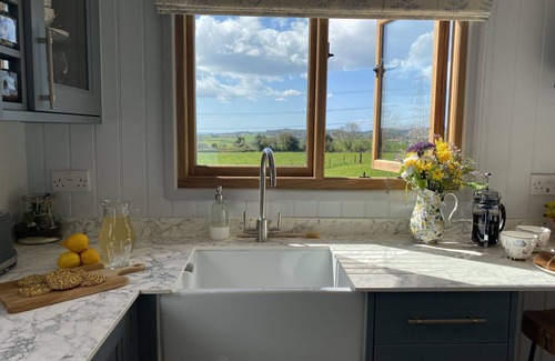 Bridport Cabina | This bespoke handmade shepherd's hut, has a stylish modern interior which includes a well-equipped k