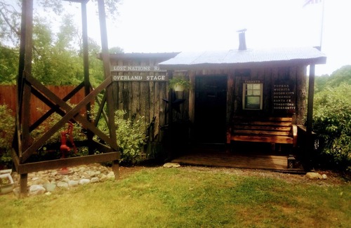 Frontier Cabina | Hunting Cabin Rustic Handcrafted primitive sits in our unique rustic Cowboy Town