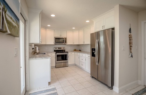 Micco Casa | Indian River Waterfront Home with private dock, heated pool, fenced back yard