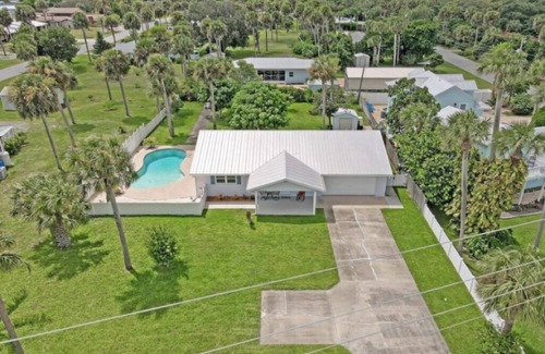 Micco Casa | Indian River Waterfront Home with private dock, heated pool, fenced back yard