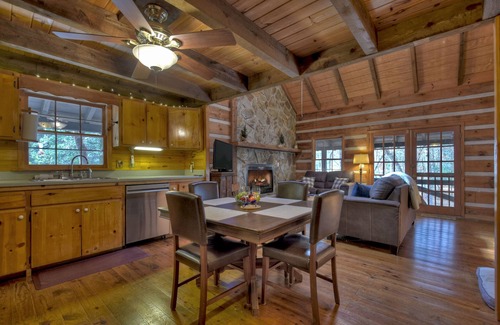 Dial Cabina | Indulge in "Just One More Night", a pet-friendly creekfront retreat boasting a spacious outdoor deck, hot tub, firepit, and WiFi