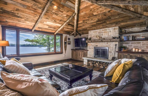 Presque Isle Cabina | Lakefront home on snowmobile trail with kayaks/SUP, fireplace, game room & AC