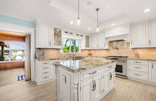 Palm City Casa | Light House Point Canal Front Pool Home with Dock and Ice Machine