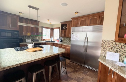 Maple City Cabina | Lodge-style multi-level home at the Homestead in Glen Arbor. Deck with grill.