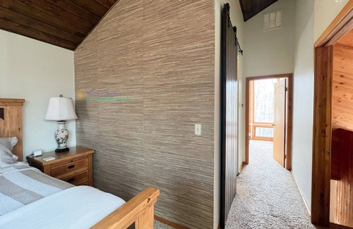 Maple City Cabina | Lodge-style multi-level home at the Homestead in Glen Arbor. Deck with grill.