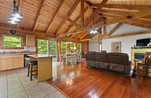 Zoe Cabina | Log Home with fenced in deck & screen porch, cosmopolitan style ranch design.