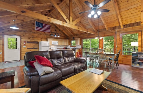 Zoe Cabina | Log Home with fenced in deck & screen porch, cosmopolitan style ranch design.