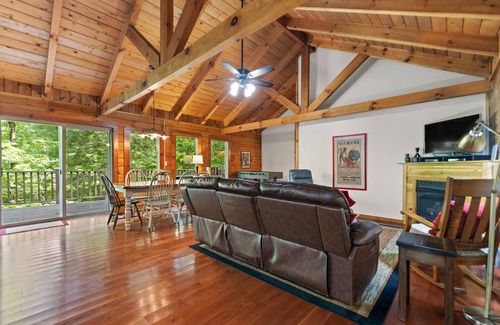 Zoe Cabina | Log Home with fenced in deck & screen porch, cosmopolitan style ranch design.