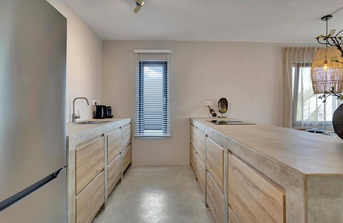 Tera Kora Casa | Luxury semi-detached water villa with 2 apartments, SUP boards, barbecue, and access to a shared pool, jacuzzi on the terrace (ground floor), and air conditioning in bedrooms and living room.