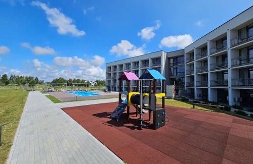 Sventoji Apartamento | Mindaugo apartamentai su šildomu baseinu, sporto sale, vaikų kambariu, work zona