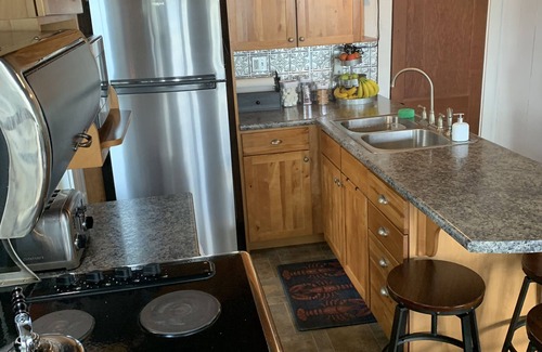 Oakland Cabaña | Modern Lakefront Camp on East Pond - cozy fire pit, 3 kayaks, canoe