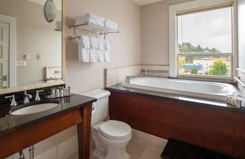Astoria Hotel | Modern Meets Victorian: Room w/ Handcrafted Cabinetry & Heated Tile Floors