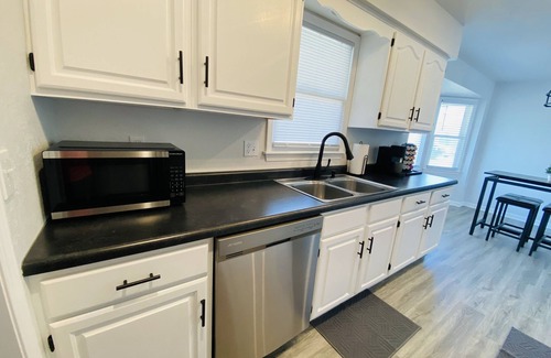 Kansas City Casa | Modern Oasis Near the Legends - Spacious home with games, patio, deck and more!